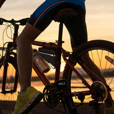Cyclist with All In One Bike Repair Kit With 16 Tools Mini Pump Tire Levers Patches And Water Resistant Triangle Frame Bag at sunset