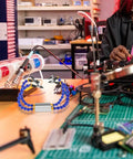 Four Arm Soldering Station With Base Pro Grade Adjustable PCB Repair Helping Hand Tool in electronics workshop setting