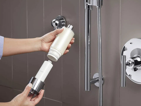 Person installing Shower Filter System For Hand Showers, Chlorine And Odor Reduction, Skin And Hair Friendly Water on chrome shower head.