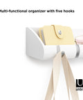 Cubby Entryway Organizer With Mail, Phone, And Wallet Compartment Plus Five Flip Up Hooks For Keys And Small Accessories, White Keeps Everyday Essentials Within Reach And Tidy, showing close-up of mail and glasses on shelf.