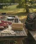 Roll Style Spice Organizer for Camping and Travel Portable Pouch on a picnic table with spices and camping gear.