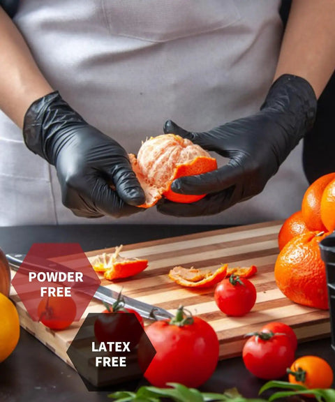 Person using Dang Tough Heavy Duty Black Nitrile Gloves Six Mil Thick Flexible Shell while peeling an orange on a cutting board.