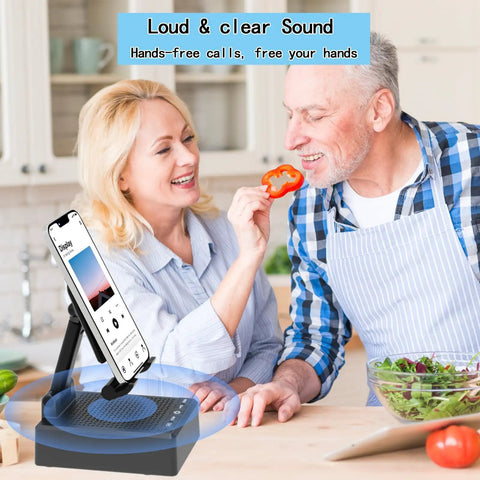 Two In One Bluetooth Speaker Phone Stand With Antislip Base And HD Surround Sound on a kitchen counter with people nearby.