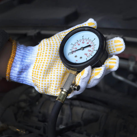 Hand holding universal oil pressure tester kit gauge