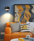 Rechargeable Battery Operated Wall Sconce Twin Pack With 3 White And 13 RGB LED Lights on blue wall above orange couch.