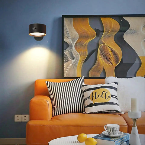 Rechargeable Battery Operated Wall Sconce Twin Pack With 3 White And 13 RGB LED Lights on blue wall above orange couch.