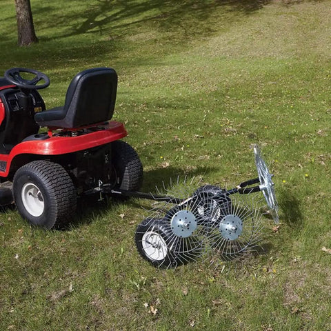 Acreage Lawn Rake With Four Tine Steel Tow Behind Dethatcher attached to a red lawn tractor on a grassy lawn, 48 inch wide.