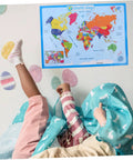 Children playing under a colorful laminated world map poster for kid friendly wall decor educational geography chart. 60x45 cm.