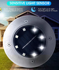 Close-up of Solar Disk Lights For Outdoor Landscaping And Pathways No Fuss LED Easy Stake Mount Waterproof Stainless Steel Tops