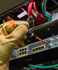 Electrician using 8-In-1 Insulated Screwdriver Set With Case 1000V Rated on server rack, wearing safety gloves.