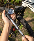 High Pressure Mountain Bike Shock Pump With Gauge For 300 PSI Front Fork And Rear Suspension No Loss Air Pump Easy Dial Tuning For A Smoother More Responsive Ride in use on MTB front fork.