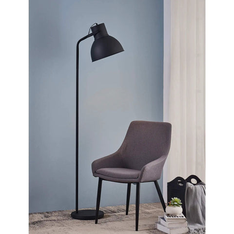 Tall Matte Black Modern Floor Lamp With Adjustable Shade for Living Room and Office next to a grey chair.