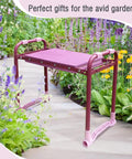 Side view of the Upgraded Garden Kneeler And Seat With Rugged Steel Frame in a garden path, highlighted among flowers.