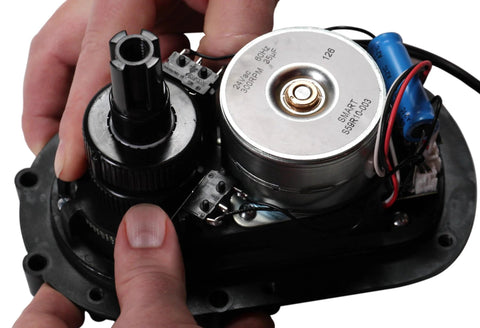 Intermatic PE24GVA 24V compact valve actuator — close-up of gear train, motor, and wiring.