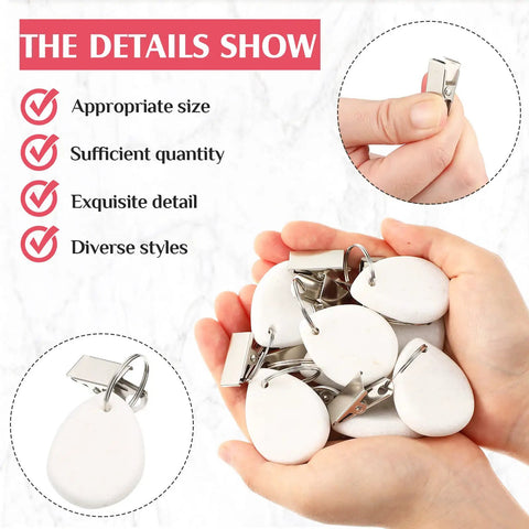 Hands holding 24 Piece Teardrop Tablecloth Weights with Marble Pendant Stones and Metal Clips for Outdoors, white.