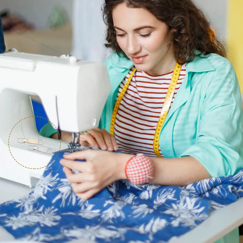 Woman using sewing machine with blue floral fabric, focus on Nine Piece Zipper Pull Replacement Kit Includes Metal Zipper Tabs For Luggage