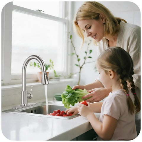 Slick Brushed Nickel Kitchen Faucet With Pull Down Sprayer High Arc Spout 18 Inch Hose, mom and daughter washing veggies in sink.