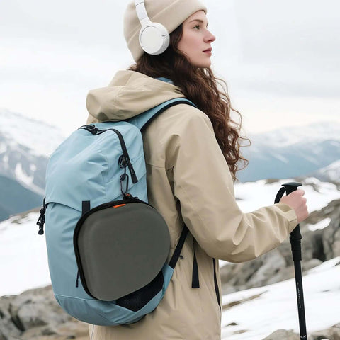 Heavy Duty Hard Shell Headphone Case, tight universal travel pouch clipped on blue backpack during outdoor hike.