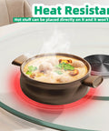 26.7 Inch Tempered Glass Lazy Susan with hot pot, highlighting heat resistance on a dining table, 68 cm diameter.