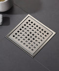 6 Inch Brushed Nickel Square Shower Drain With Adjustable Base Flange In SUS304 Stainless Steel on tiled floor