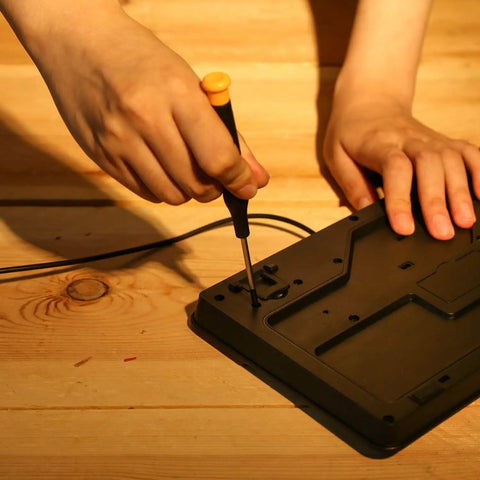 Person using screwdriver from 208 Piece General Household Hand Tool Kit With Plastic Storage Case Auto And Home Repair Ready DIY Set