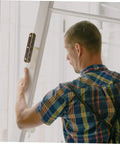 Man installing heavy duty piano hinge set on a door.