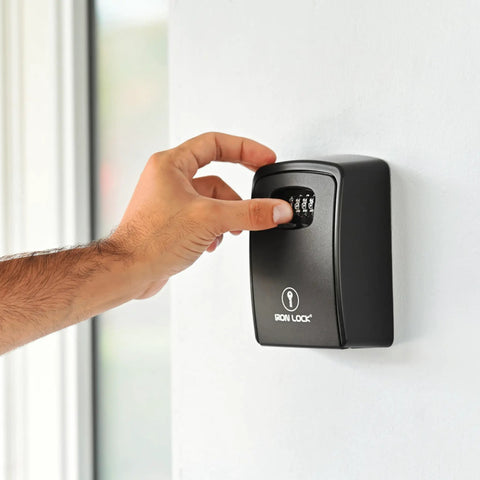 Hand adjusting 4-digit combination on XXL Wall Mount Key Lock Box Outdoor Key Safe Waterproof Heavy Duty Metal Body for secure access.