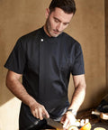 Kickass Black Men Chef Coat With Dope Breathable Mesh Short Sleeve Lightweight Jacket For Kitchen And Bakery Uniform Featuring Slick Oblique Collar And Handy Sleeve Pocket For Hitting The Heat, chef slicing avocado.