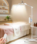 Adjustable LED lamp with remote in a spa room near bed, used for Lash Light Half Moon Magnifying Desk Lamp With 10X Optical Glass.