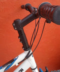 Close-up of bike with Bike Stem Riser And Handlebar Extender For MTB And BMX Aluminum Alloy Head Up Adapter installed.