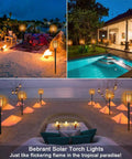 43 Inch Solar Torch Lights With Realistic Flickering Flames 2 Pack illuminating festive backyard areas at night