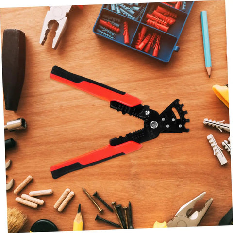 Badass Heavy Duty Wire Stripper And Crimper Pliers With Slick Bending Jaw Pro Grade Electrician Gear on a workspace surrounded by tools.