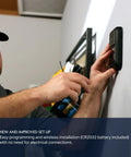 Person installing MyQ Battery Powered Wall Control For Garage Doors Quick Wireless Install No Wiring Needed on wall.