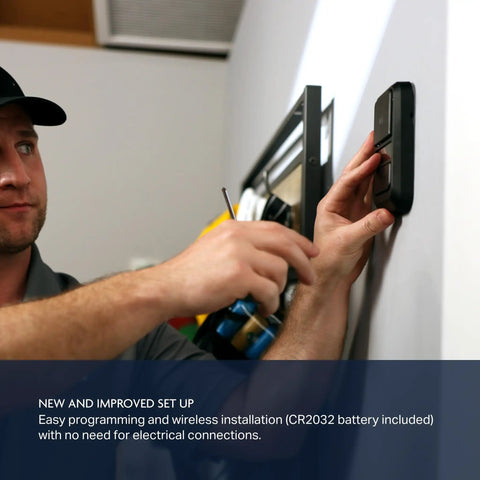 Person installing MyQ Battery Powered Wall Control For Garage Doors Quick Wireless Install No Wiring Needed on wall.