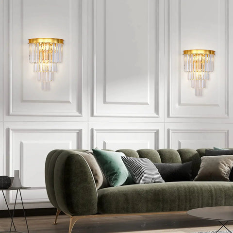 Gold Crystal Wall Sconce Lighting Fixture With Four Tier K9 Crystals in living room above green sofa.
