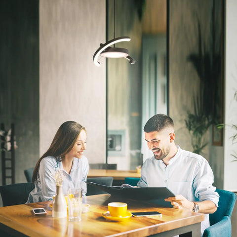 Straight Fire Vibe For Your Home Decor Featuring Fresh Saturn Ring Pendant Light With Remote Dimming And Sleek Black Overhead Ceiling Fixture For Kitchen Or Dining Room in a warm dining space.
