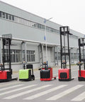 Heavy Duty Electric Hand Pallet Jack Stacker With 3000mm Lift Height For Warehouse Floor, Factory Floors And Logistics Ops Handles 1000kg To 3000kg Loads Smoothly, multiple colors of pallet jacks standing on a factory floor.