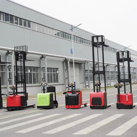 Heavy Duty Electric Hand Pallet Jack Stacker With 3000mm Lift Height For Warehouse Floor, Factory Floors And Logistics Ops Handles 1000kg To 3000kg Loads Smoothly, multiple colors of pallet jacks standing on a factory floor.