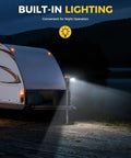 Electric Trailer Jack 5000Lb With Remote Control illuminated at night attached to an RV with built-in lighting feature, black