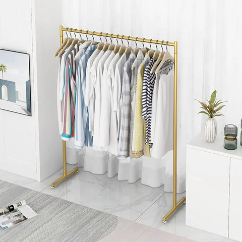 Heavy Duty Free Standing Pipe Clothes Rack With Golden Coat Hanger Durable Drying Rack in modern bedroom setting