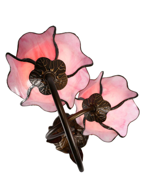Close-up view of Poelking 2-Light Pink Lily Table Lamp with bronze finish illuminating elegant glass lily panels.