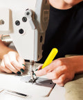 Person using LED Needle Threader Set With Lighted Wire Loop For Sewing 2 Pack Illuminated Threading Tool on sewing machine.