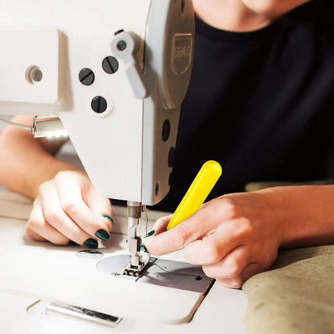 Person using LED Needle Threader Set With Lighted Wire Loop For Sewing 2 Pack Illuminated Threading Tool on sewing machine.