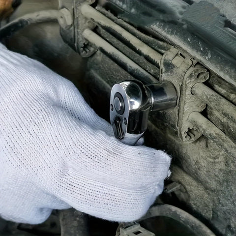 Hand using Mini Drive Ratchet Kit With Quick Release And Reversible 72 Tooth Design on car engine