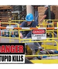 Person on job site wearing blue helmet near 'Danger Flammable Gas' sign with 'Danger Stupid Kills' hard hat sticker visible.