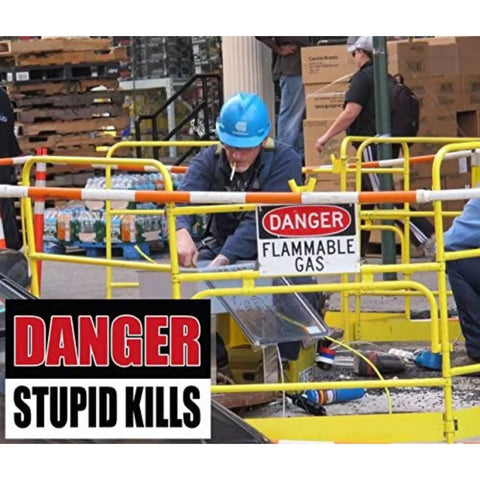 Person on job site wearing blue helmet near 'Danger Flammable Gas' sign with 'Danger Stupid Kills' hard hat sticker visible.