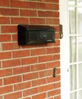 Townhouse Wall Mount Mailbox in Black, Small Capacity Galvanized Steel Build, Rust Resistant Powder Coat on brick wall
