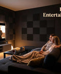 Couple enjoying a movie night in a soundproofed room with 96 Pack Black Acoustic Foam Tiles That Hits Hard On Room Echo And Gives Your Vocal Booth Pro Level Clarity Includes No Sweat Double Sided Tape For Instant Setup And Heavy Duty Sound Dampening For Home Studios.