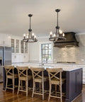 Wagon Wheel Black Farmhouse Chandelier With 4 Lights above kitchen island, rustic wooden stools, white cabinets, cozy glow