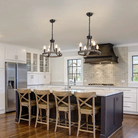 Wagon Wheel Black Farmhouse Chandelier With 4 Lights above kitchen island, rustic wooden stools, white cabinets, cozy glow